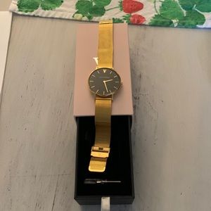 Gold and black Paul valentine watch with watch adjuster.